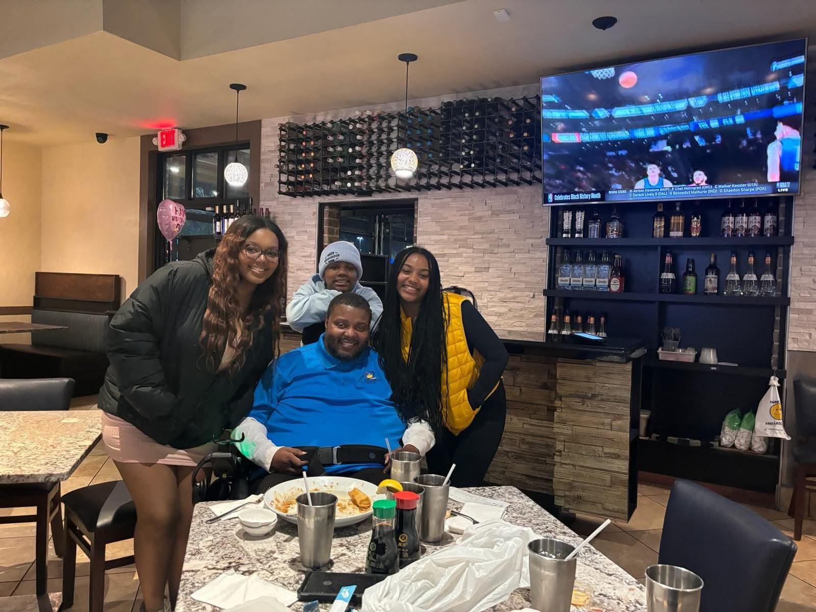 Lamont with three people at a restaurant