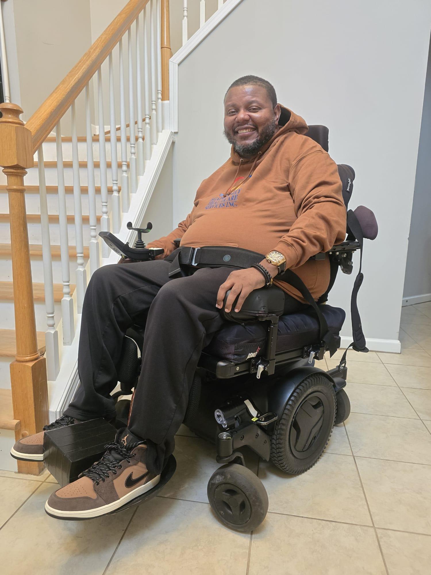 Lamont smiling in an Agape Family Healthcare Services sweatshirt