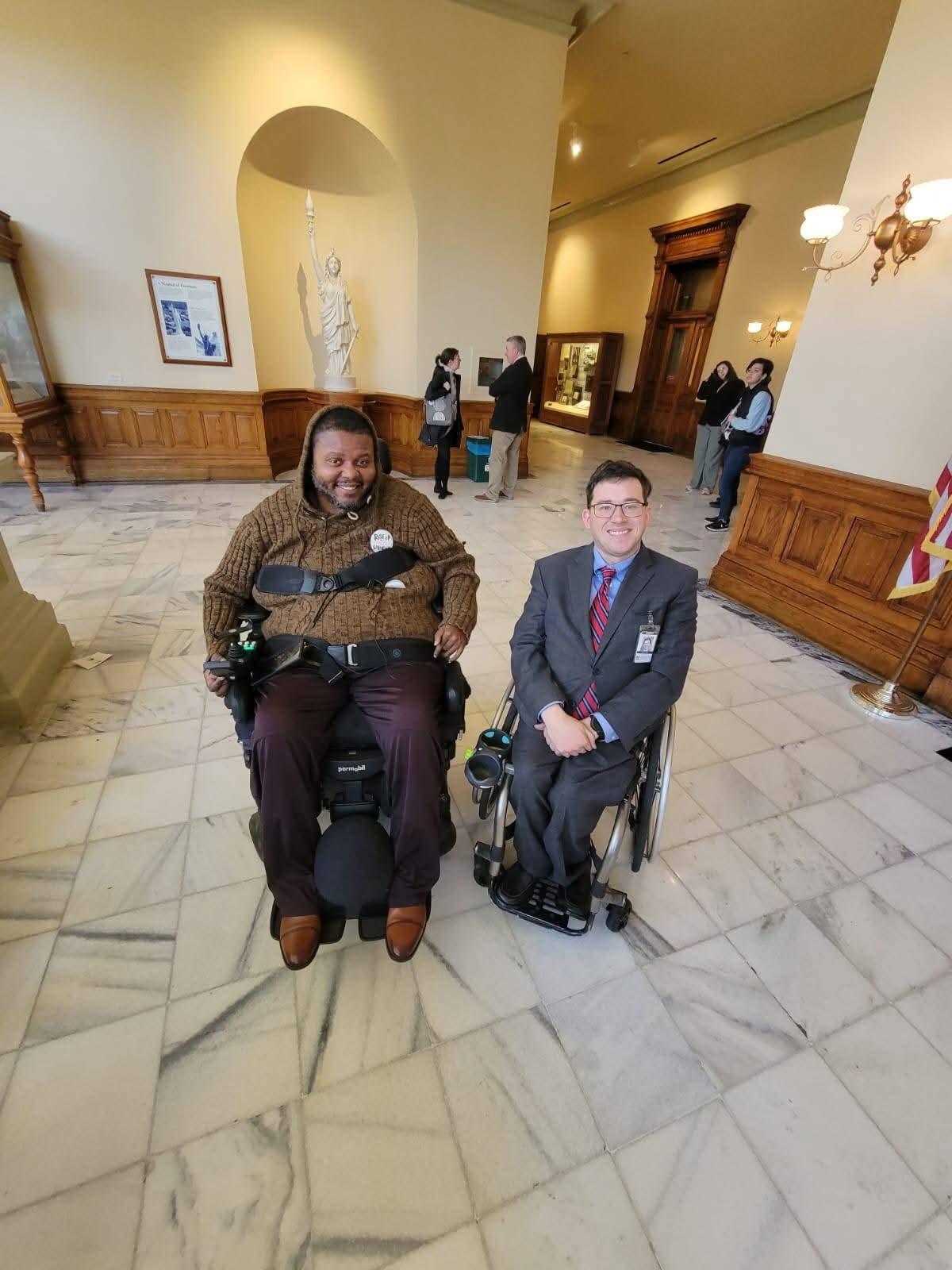 Lamont with another attendee inside a public building