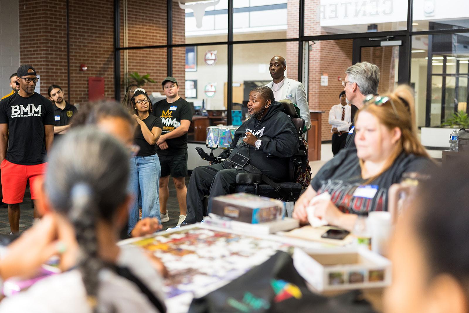 Lamont speaking with people at a Brothers Making Moves gathering