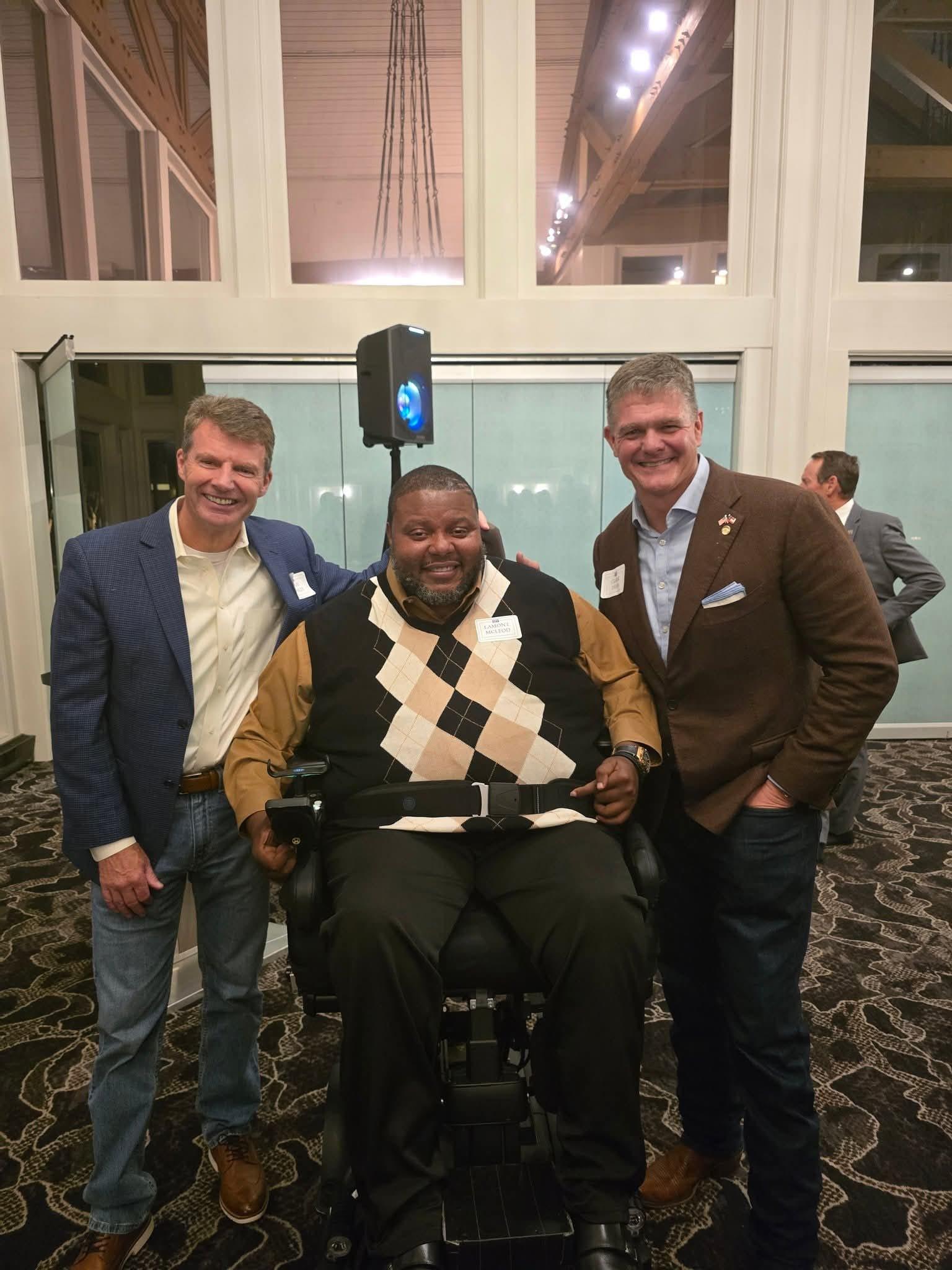 Lamont with two attendees at a professional gathering