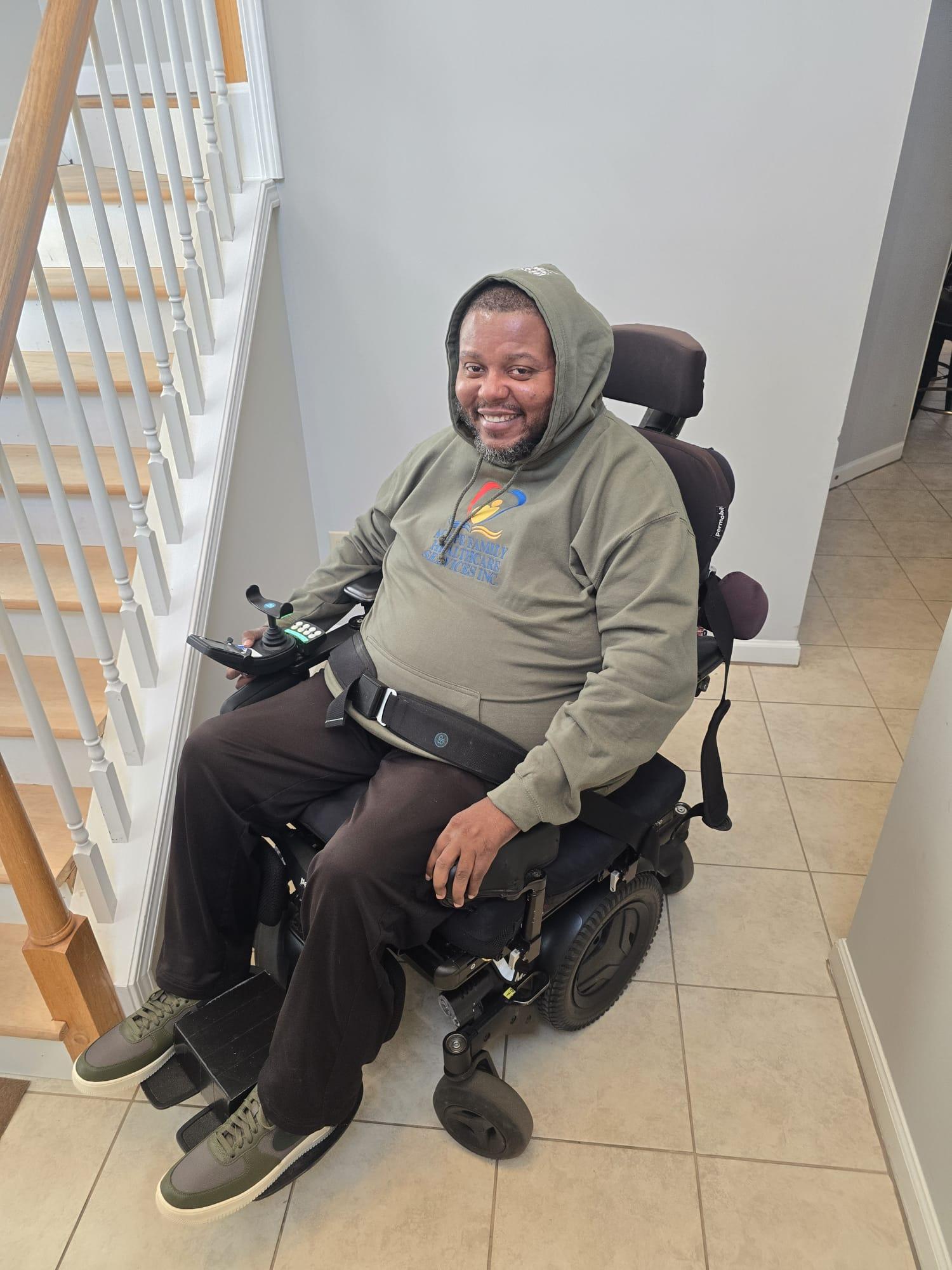 Lamont wearing an Agape Family Healthcare Services sweatshirt